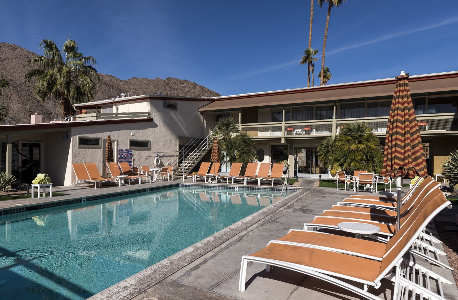 A mid-century hotel pool beneath the San Jacinto mountains in Palm Springs